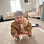 baby, carpet, child, clothing, couch, cute, floor, happy, home, indoor, jacket, living_room, person, portrait, smiling, sock, sofa, toddler, toy, window