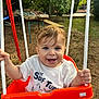 Mehmetcan a rejoint le concours — aidez-le/la à gagner de superbes lots ! toddler, child, swing, outdoor, smiling, happy, blue_eyes, white_tshirt, orange_swing, ropes, garden, greenery, daylight, play, fun, seat, casual_clothing, nature, person, portrait