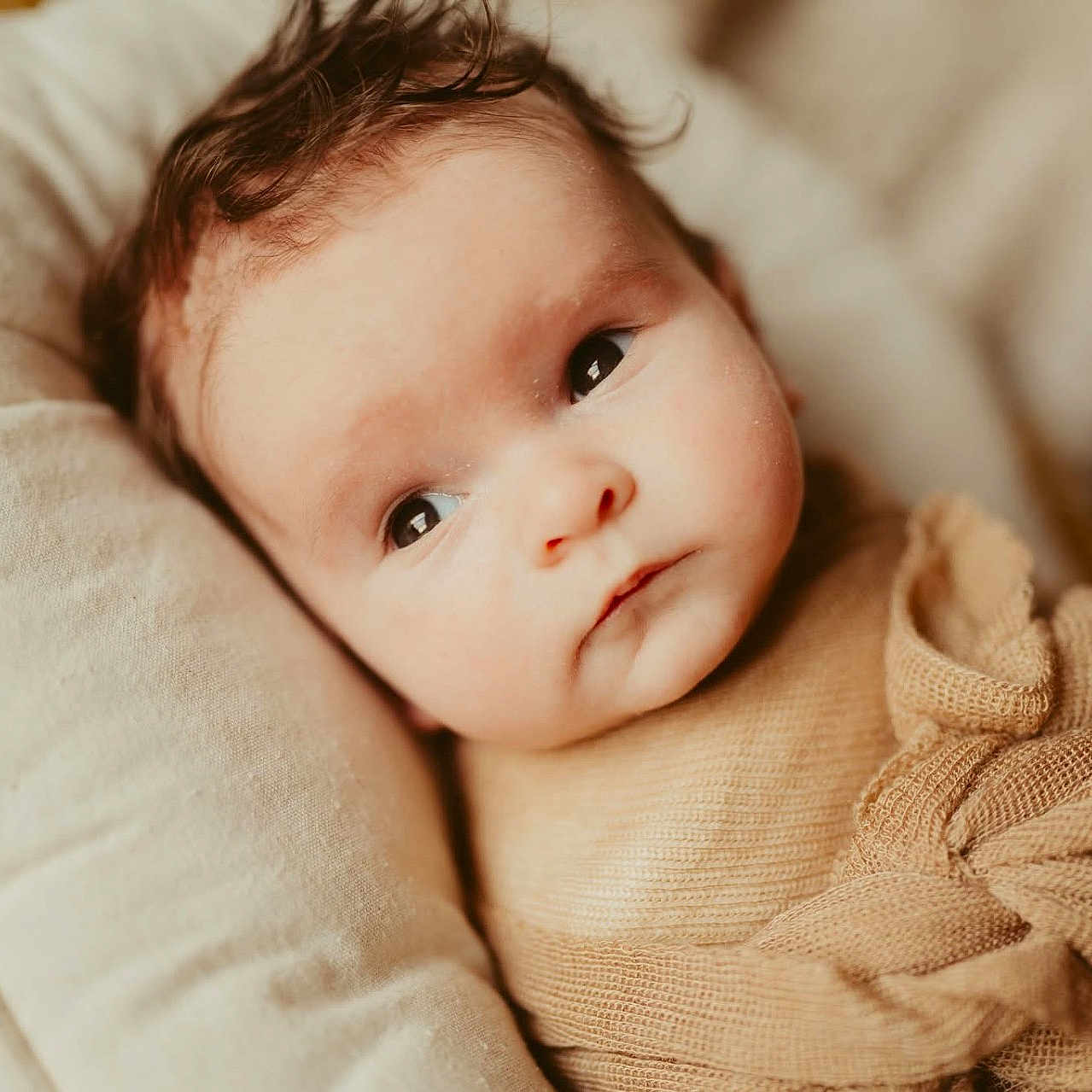 Jaxon is registered to the contest to win money with this photo: baby, blanket, blonde, face, hair, happy, head, newborn, person, photography, portrait, quilt, smile