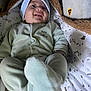 Soan participe au concours pour gagner de l'argent avec cette photo : baby, infant, smiling, onesie, hat, blanket, pattern, cozy, soft, cute, happy, lying_down, child, newborn, warm, indoors, portrait, sleepwear, footed_pajamas, toddler