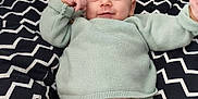 Raphaël participe au concours pour gagner de l'argent avec cette photo : baby, button, child, clothing, cozy, cushion, cute, face, happy, indoor, infant, knitwear, pastel_colors, person, portrait, relaxed, seated, smile, soft_fabric, zigzag_pattern