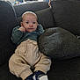Raphaël participe au concours pour gagner de l'argent avec cette photo : baby, child, clothing, couch, cozy, cushion, cute, face, furniture, home, indoor, infant, looking_at_camera, pants, person, relaxing, seated, socks, sofa, sweater