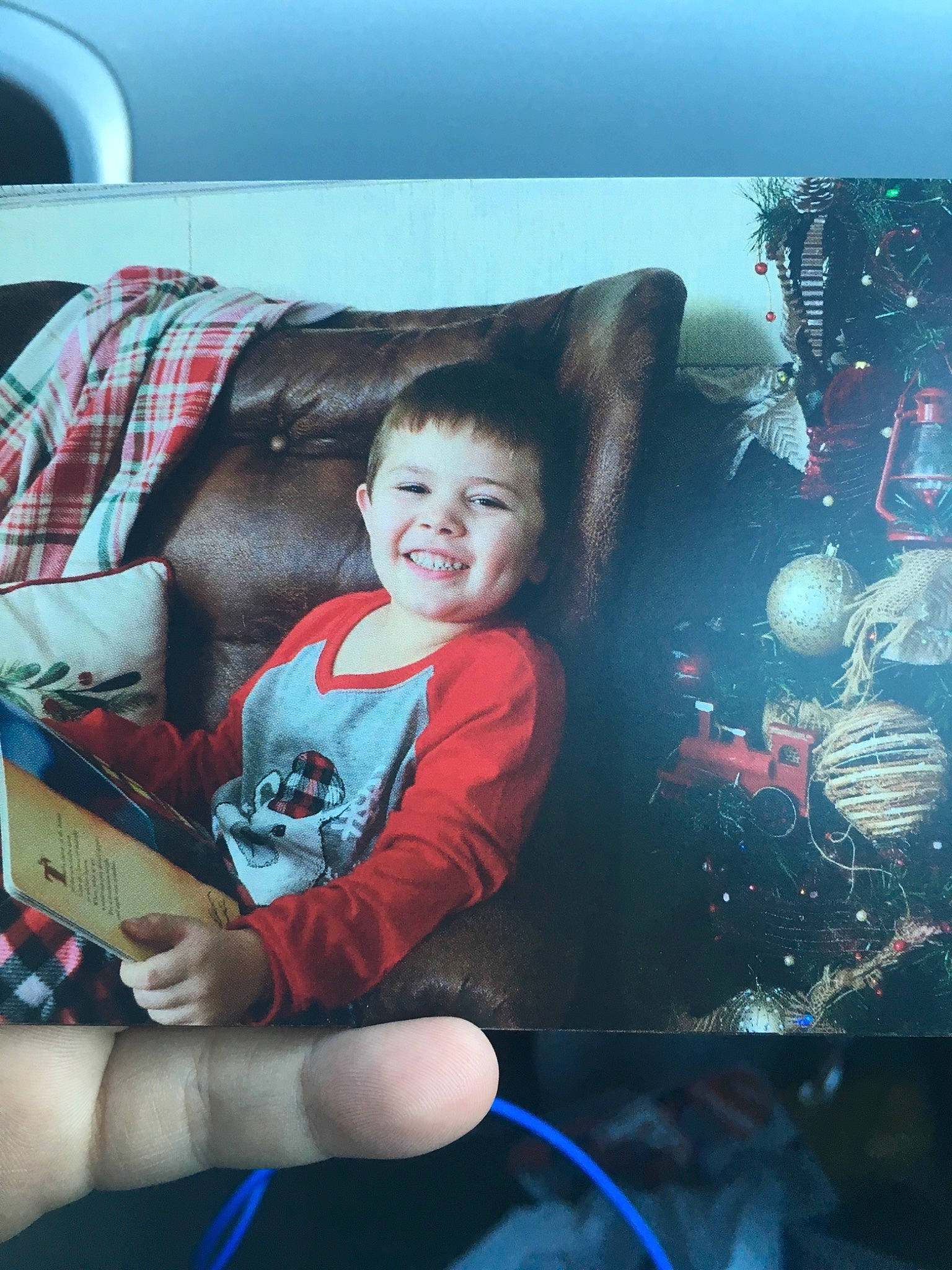 Dalton is registered to the contest to win money with this photo: child, christmas, cool, electronic_device, joy, leg, person, photography, red, room, sitting, skin, smile, snapshot, technology, toddler, tree, vacation, world