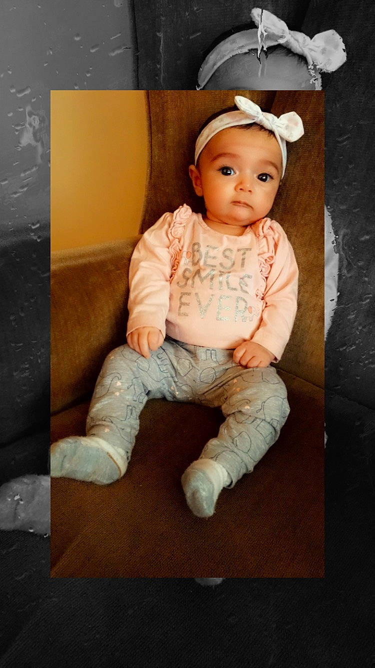 Thea is registered to the contest to win money with this photo: baby, baby_toddler_clothing, cheek, child, child_model, person, portrait, sitting, smile, toddler