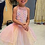 Estella Giovanna is registered to the contest to win money with this photo: adult, child, crocs, door, fan, fashion, floor, floral_dress, girl, happy, indoor, joyful, person, pink_dress, playful, smiling, standing, striped_shirt, tutu, young_child