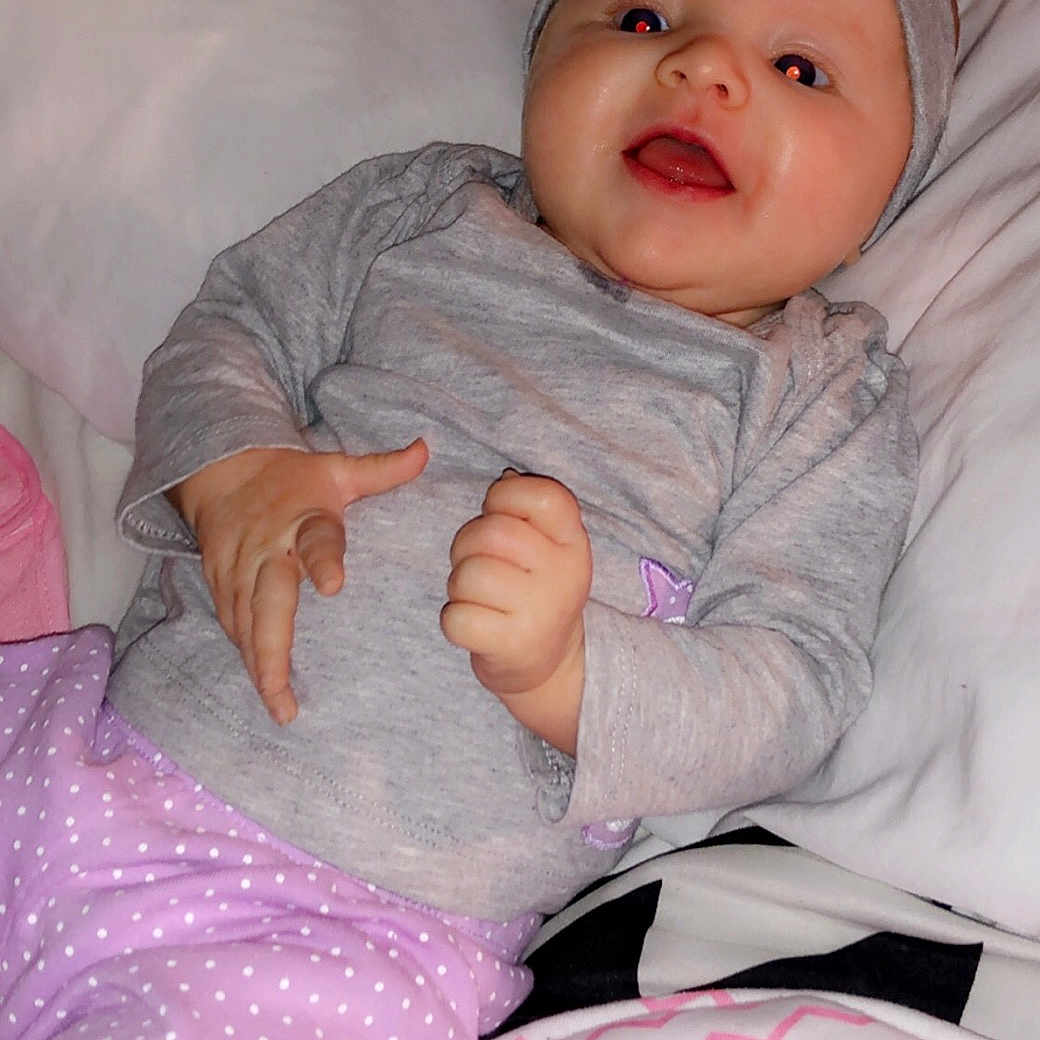 Payslee is registered to the contest to win money with this photo: baby_products, bed, bedtime, cheek, child, day, eye, girl, head, human_hair_color, infant, leg, nose, person, pink, product, purple, sitting, skin, textile
