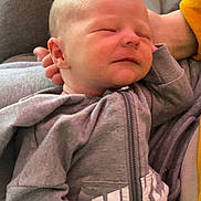 Christopher joined the competition — help win amazing prizes! baby, casual_wear, child, close_up, clothing, cute, gray_hoodie, hand, human, indoors, infant, newborn, peaceful, person, portrait, relaxed, resting, sleeping, smile, toddler