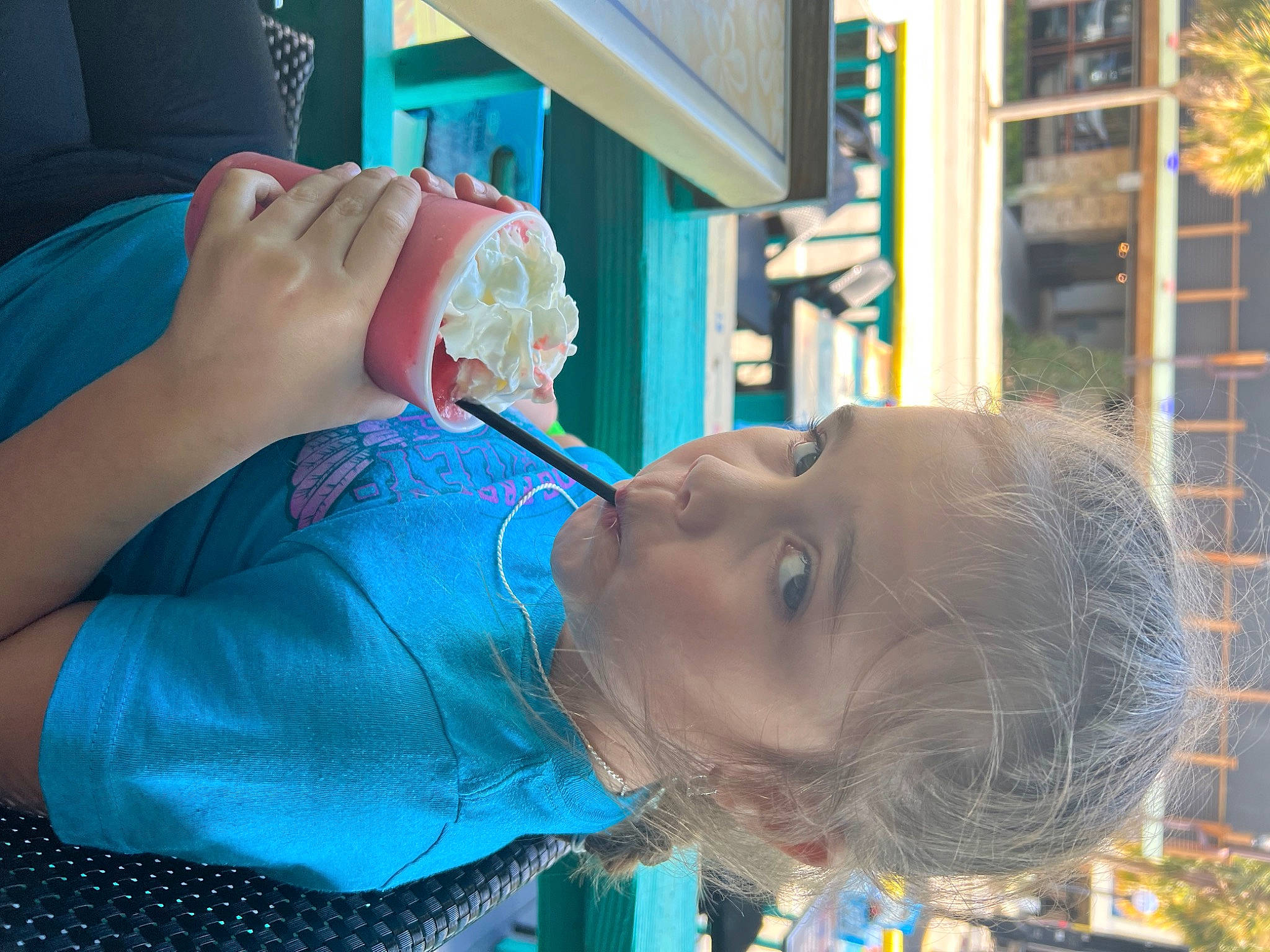Khloé is registered to the contest to win money with this photo: baby, blue, child, drinking, drinkware, electric_blue, fast_food, food, fun, green, happy, leisure, mouth, nail, neck, person, play, tableware, toddler, vacation