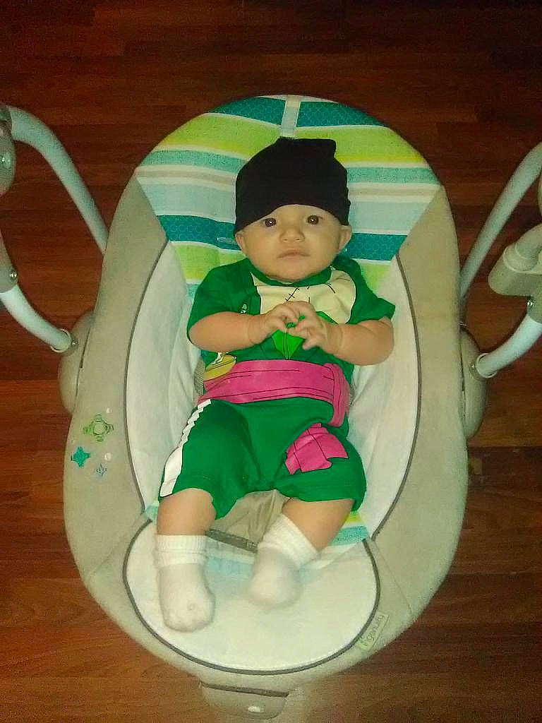 Zen is registered to the contest to win money with this photo: baby, baby_products, baby_toddler_clothing, cap, child, circle, costume, costume_hat, doll, fashion_accessory, fictional_character, hat, headwear, party_supply, pattern, person, sitting, sock, stuffed_toy, thigh