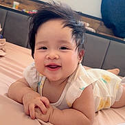 Caliah Fleur Catchin is registered to the contest to win money with this photo: baby, bed, blanket, child, clothing, cozy, cute, expression, face, hair, hands, happy, indoor, infant, lying_down, portrait, skin, smiling, soft, toddler