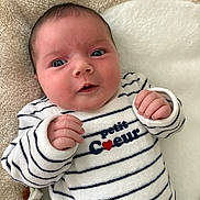 Anaé participe au concours pour gagner de l'argent avec cette photo : baby, infant, newborn, face, eyes, cheeks, hands, striped_clothing, onesie, blanket, plush_bed, lying_down, portrait, cute, cozy, soft_texture, nursery, smile, white_background, navy_stripes