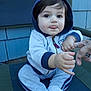 Adrian joined the competition — help win amazing prizes! toddler, child, baby, hoodie, pants, socks, sitting, chair, hand, finger, person, outdoor, blue, green, wooden_wall, playful, tongue_out, cute, cozy, casual_clothing