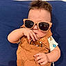 Asher joined the competition — help win amazing prizes! baby, blue_cushion, brown_outfit, casual, child, clothing, cute, expression, face, hair, hand, indoor, infant, monster_prints, person, playful, portrait, seated, sunglasses, young
