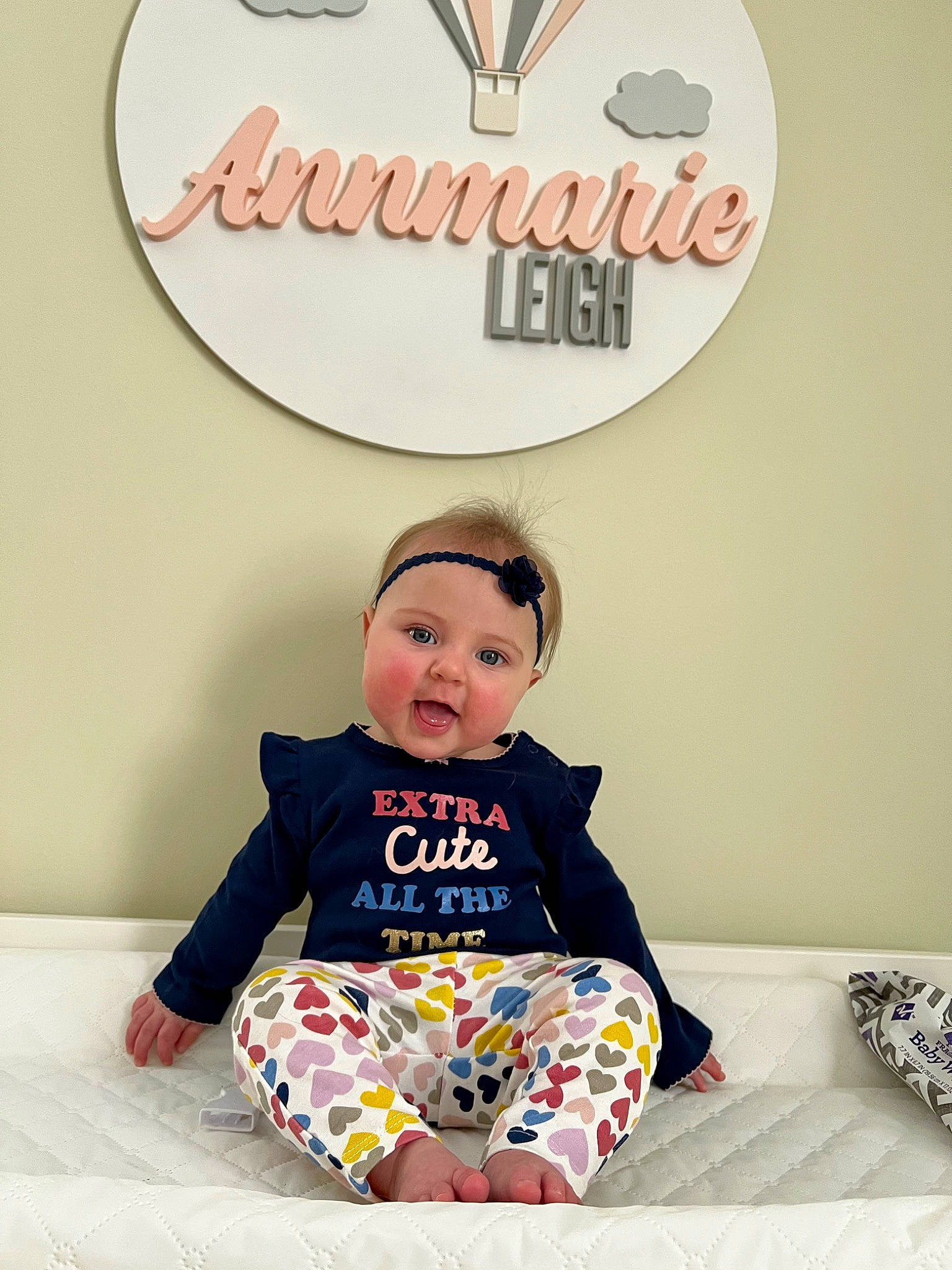 Annmarie is registered to the contest to win money with this photo: baby, baby_toddler_clothing, child, comfort, font, happy, head, headwear, hoodie, logo, pattern, person, photo_caption, play, product, room, sitting, sleeve, t_shirt, toddler