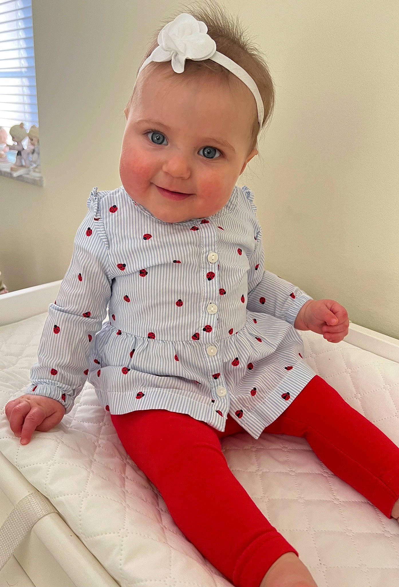 Annmarie is registered to the contest to win money with this photo: baby, baby_toddler_clothing, collar, comfort, finger, happy, headgear, human_leg, joy, knee, lip, pattern, person, pink, sleeve, smile, textile, thigh, toddler, waist