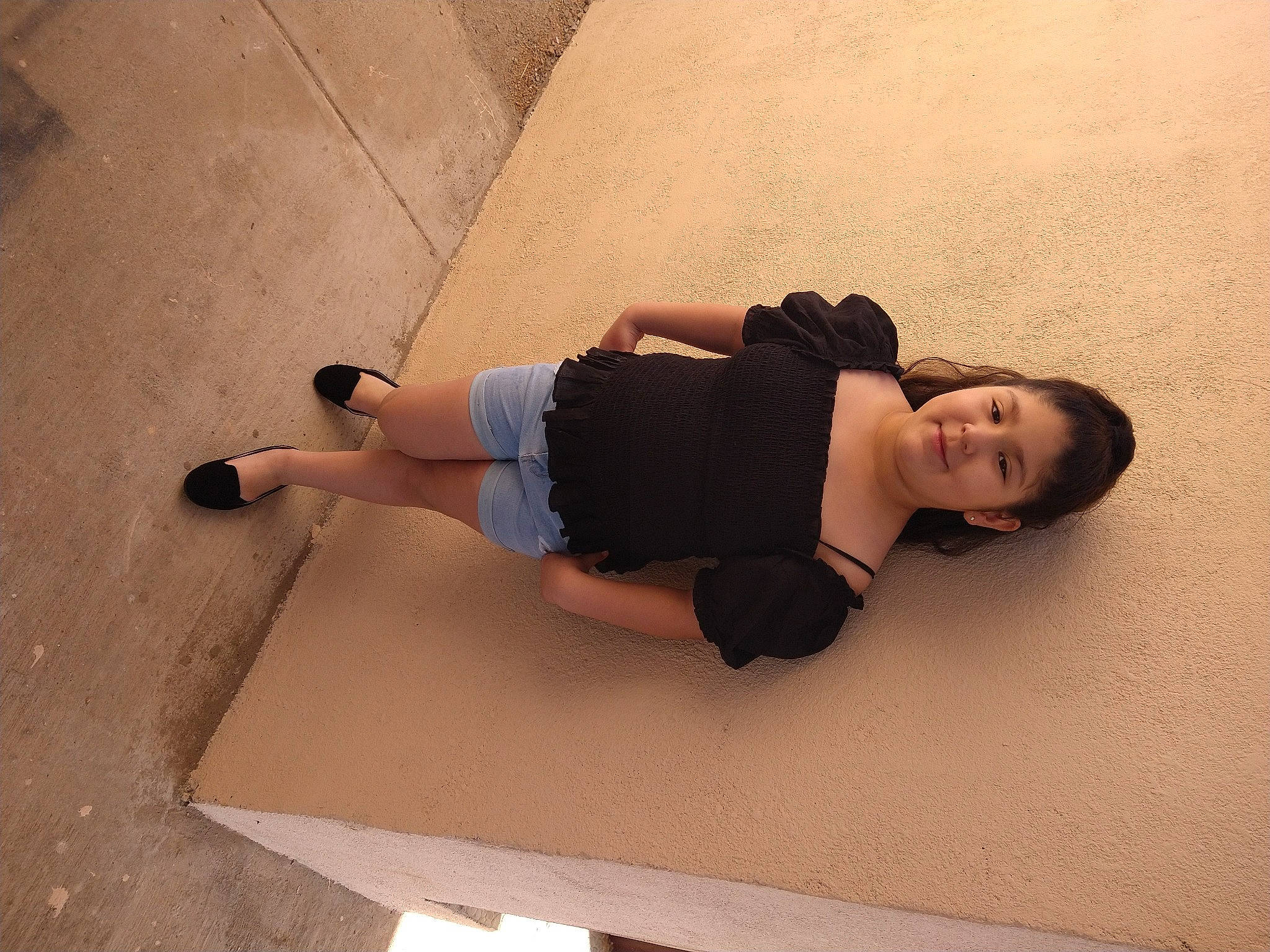 Sophia is registered to the contest to win money with this photo: barefoot, calf, comfort, elbow, floor, flooring, foot, fun, hardwood, human_leg, joy, knee, person, shorts, sitting, sleeve, t_shirt, thigh, trunk, waist