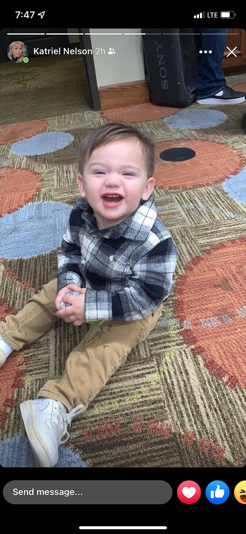 Macario is registered to the contest to win money with this photo: baby, baby_toddler_clothing, cheek, child, facial_expression, floor, flooring, grass, pattern, people, person, photograph, plaid, skin, sleeve, smile, snapshot, tartan, textile, toddler