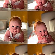 Eva joined the competition — help win amazing prizes! baby, infant, pacifier, cute, red_hair, bed, white_clothing, portrait, smiling, tongue_out, closeup, child, indoors, playful, sleepwear, chubby_cheeks, photography, expression, happy, skin