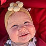 baby, smiling, face, headband, flower, blue_eyes, cheeks, clothing, blanket, red, infant, cute, closeup, child, happy, outdoor, portrait, button, fabric, warm