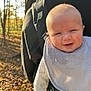 baby, child, carrier, forest, autumn, leaves, sunlight, person, outdoor, nature, trees, backpack, clothing, smile, happy, head, cute, walking, family, parent
