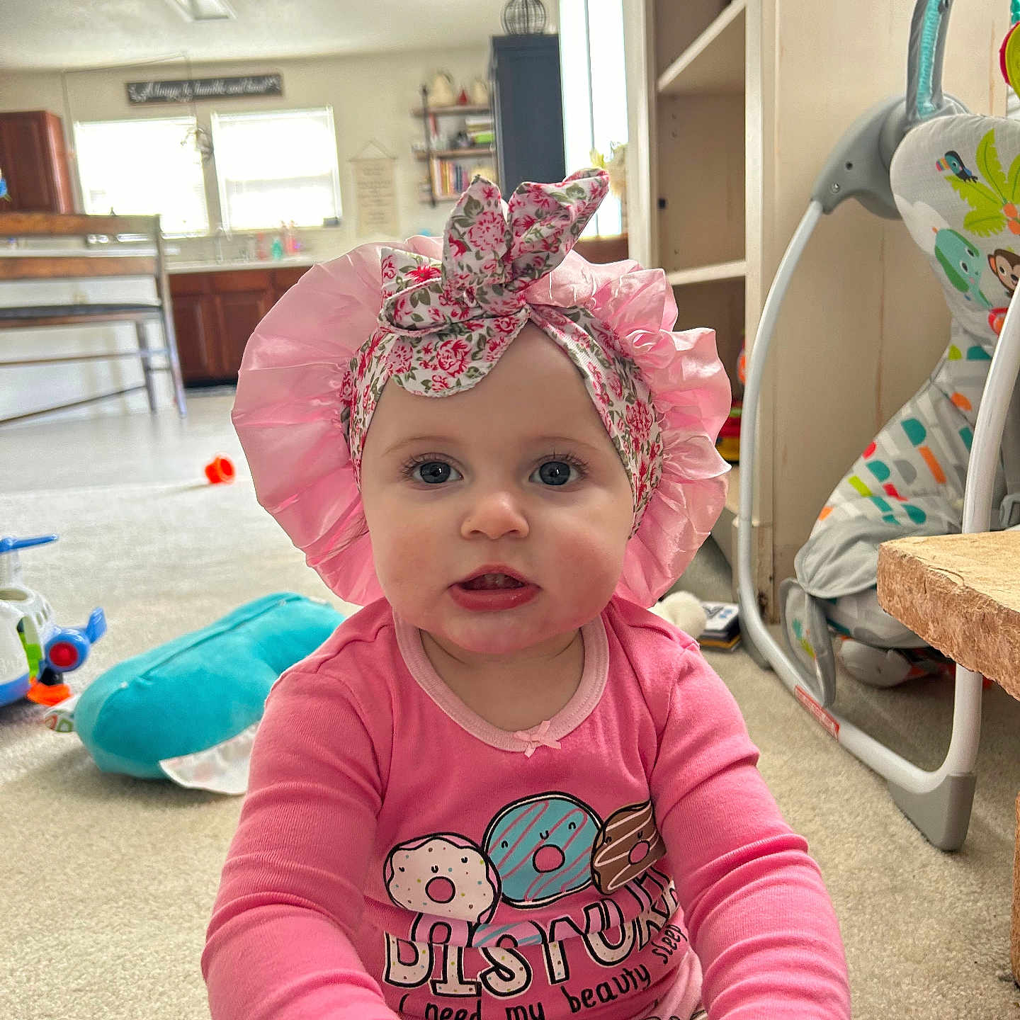 Lylamae is registered to the contest to win money with this photo: architecture, baby, bonnet, building, cap, clothing, face, furniture, hat, head, indoors, interiordesign, livingroom, person, photography, portrait, room, sitting, t_shirt, wood