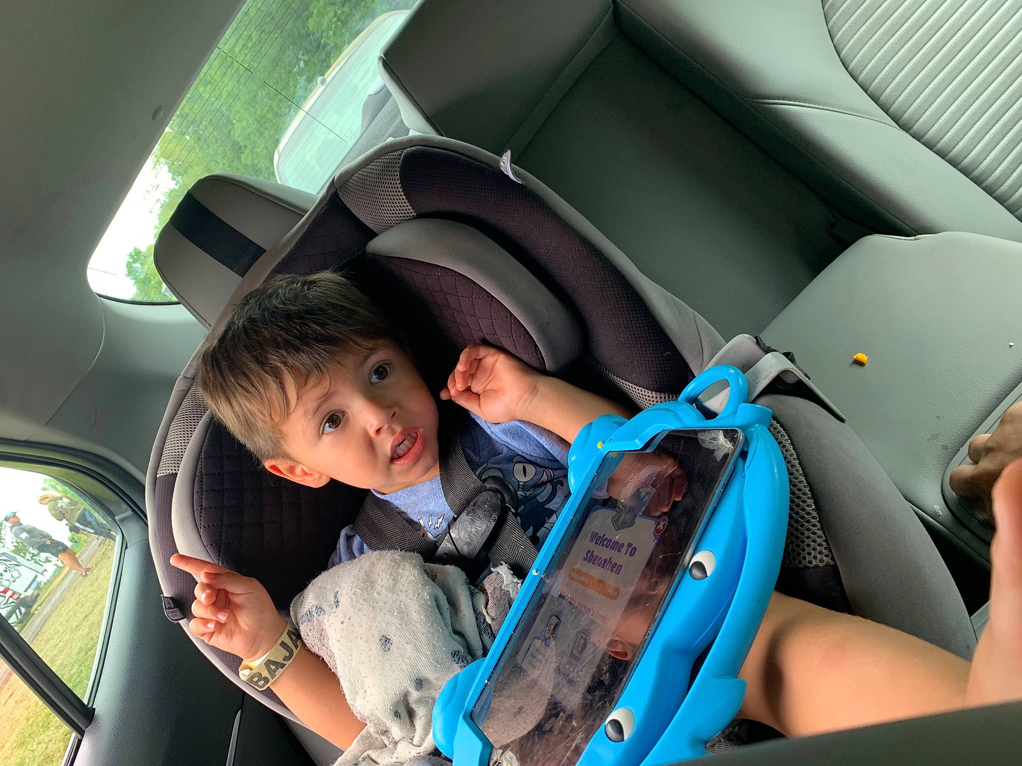 Dean is registered to the contest to win money with this photo: auto_part, automotive_design, automotive_exterior, automotive_mirror, car, car_seat, car_seat_cover, child, comfort, family_car, head_restraint, motor_vehicle, passenger, person, personal_luxury_car, seat_belt, steering_part, steering_wheel, surprise, toddler