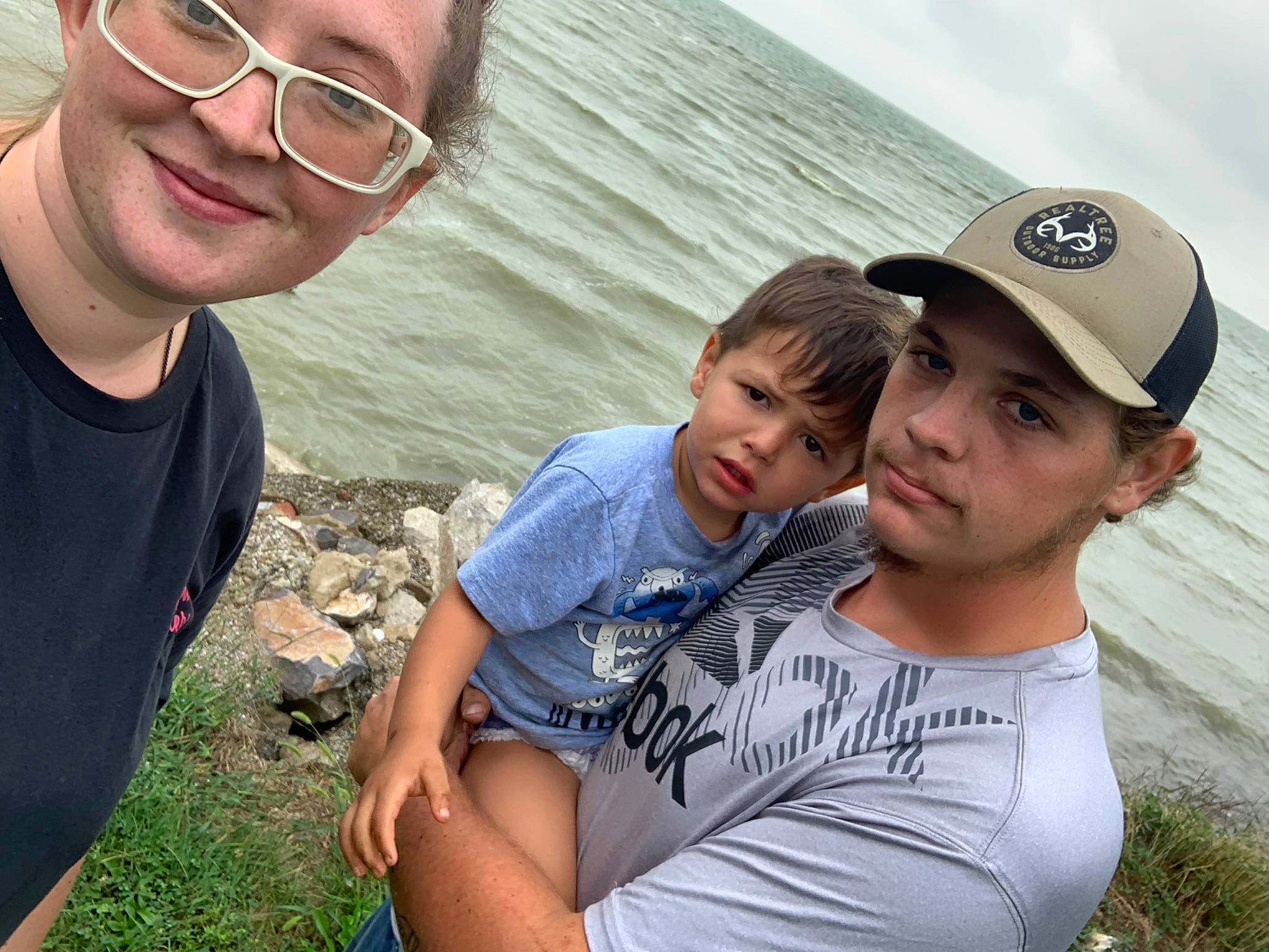 Dean is registered to the contest to win money with this photo: cool, event, face, facial_expression, friendship, fun, glasses, grass, happy, hat, headwear, human, joy, leisure, people, person, skin, smile, summer, t_shirt