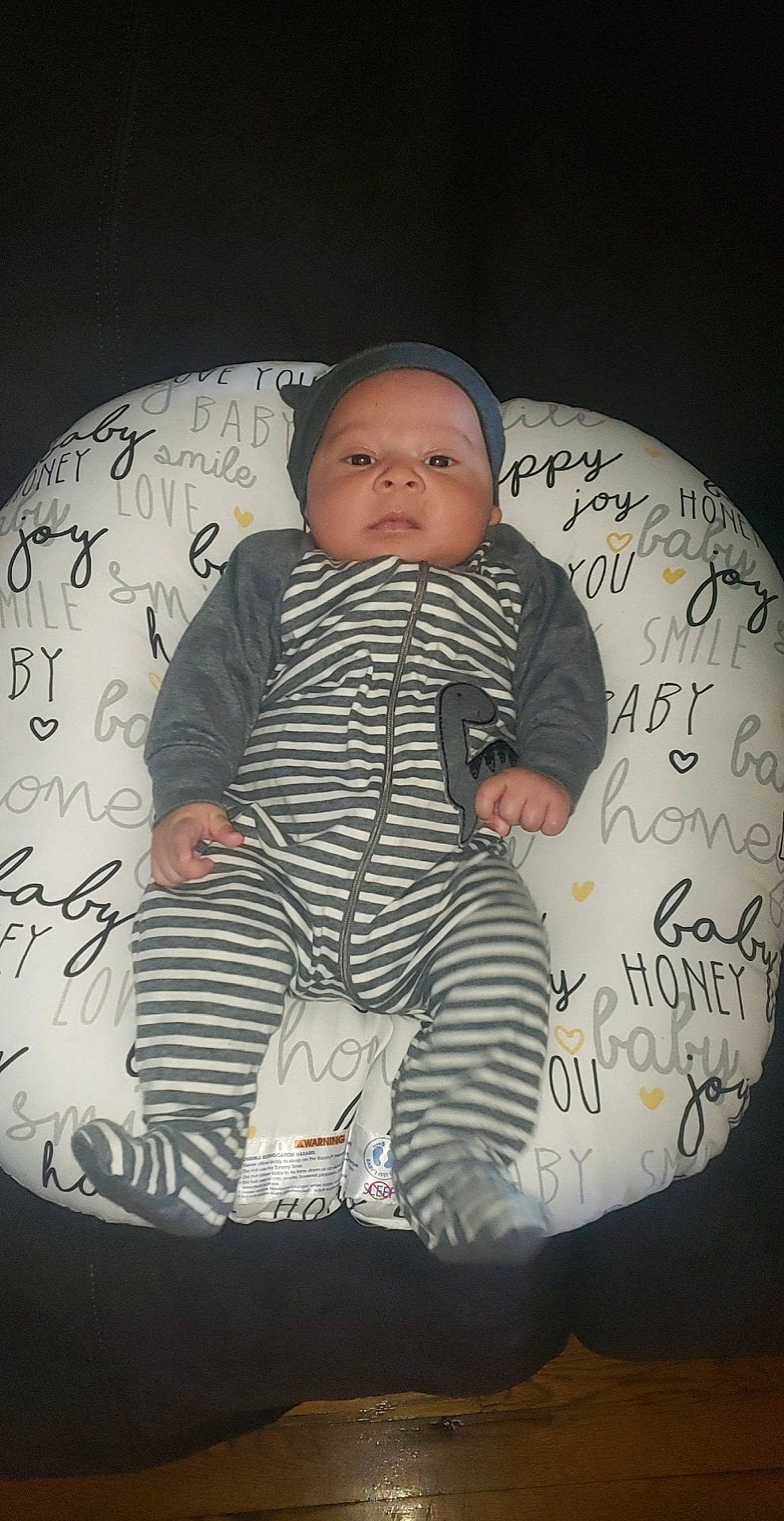 Bryce is registered to the contest to win money with this photo: baby, baby_products, baby_sleeping, baby_toddler_clothing, child, comfort, design, finger, flash_photography, font, headwear, linens, monochrome_photography, pattern, person, product, room, sitting, sleeve, t_shirt