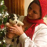 Zayley joined the competition — help win amazing prizes! woman, puppy, dog, holding, red_hat, red_scarf, white_jacket, christmas_tree, indoor, holiday, decorations, lights, festive, warm, smiling, cute, pet, love, portrait, cozy