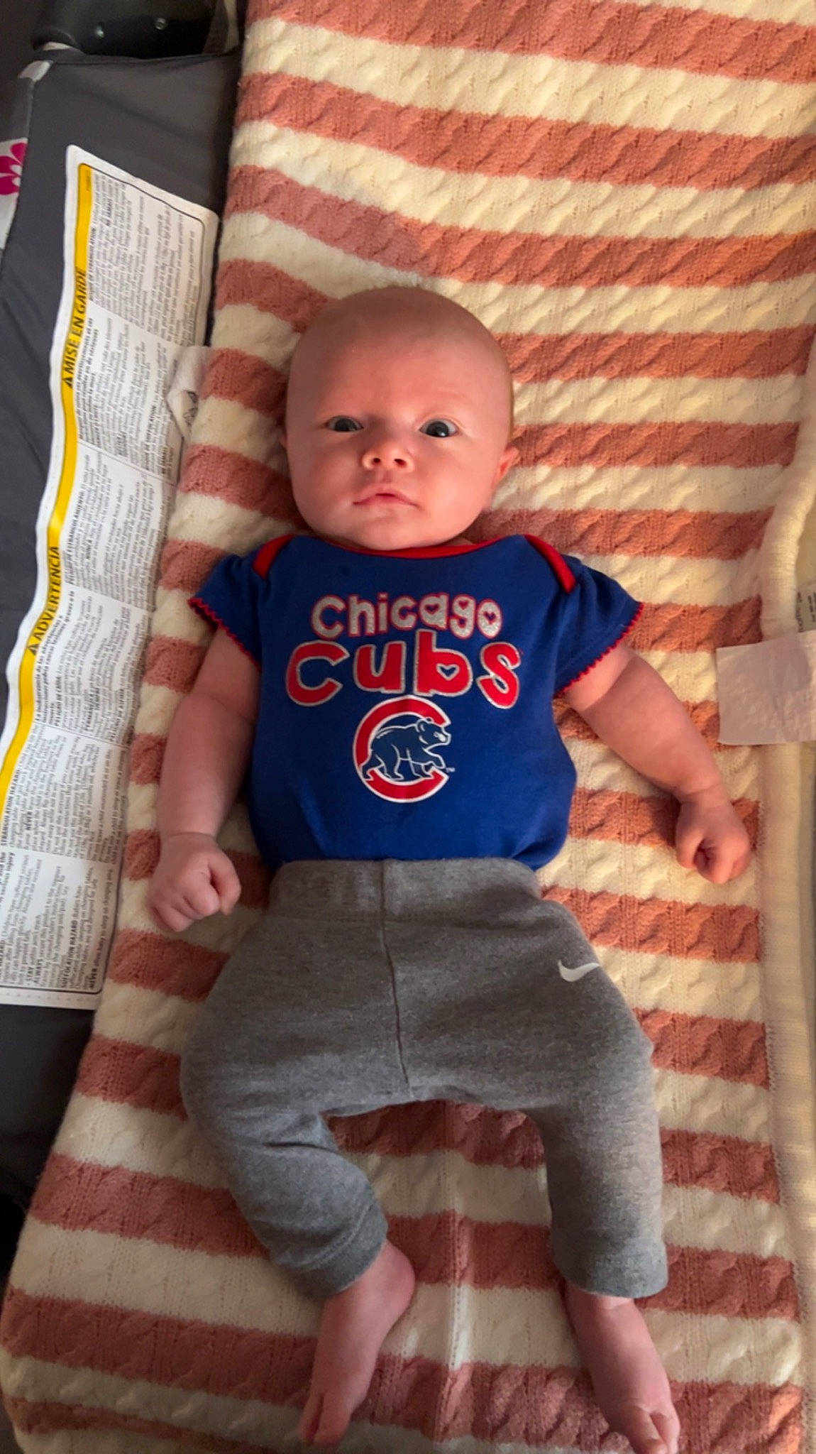 Braylynn joined the competition — help win amazing prizes! baby, baby_toddler_clothing, child, comfort, electric_blue, face, flooring, hairstyle, head, human_body, linens, orange, pattern, person, product, sitting, sleeve, t_shirt, textile, toddler