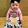 baby, infant, child, girl, headband, bow, pink_shirt, daddys_daughter, cow_print_pants, white_socks, wooden_sign, three_months, couch, golden_background, sitting, cute, portrait, happy, indoors, person