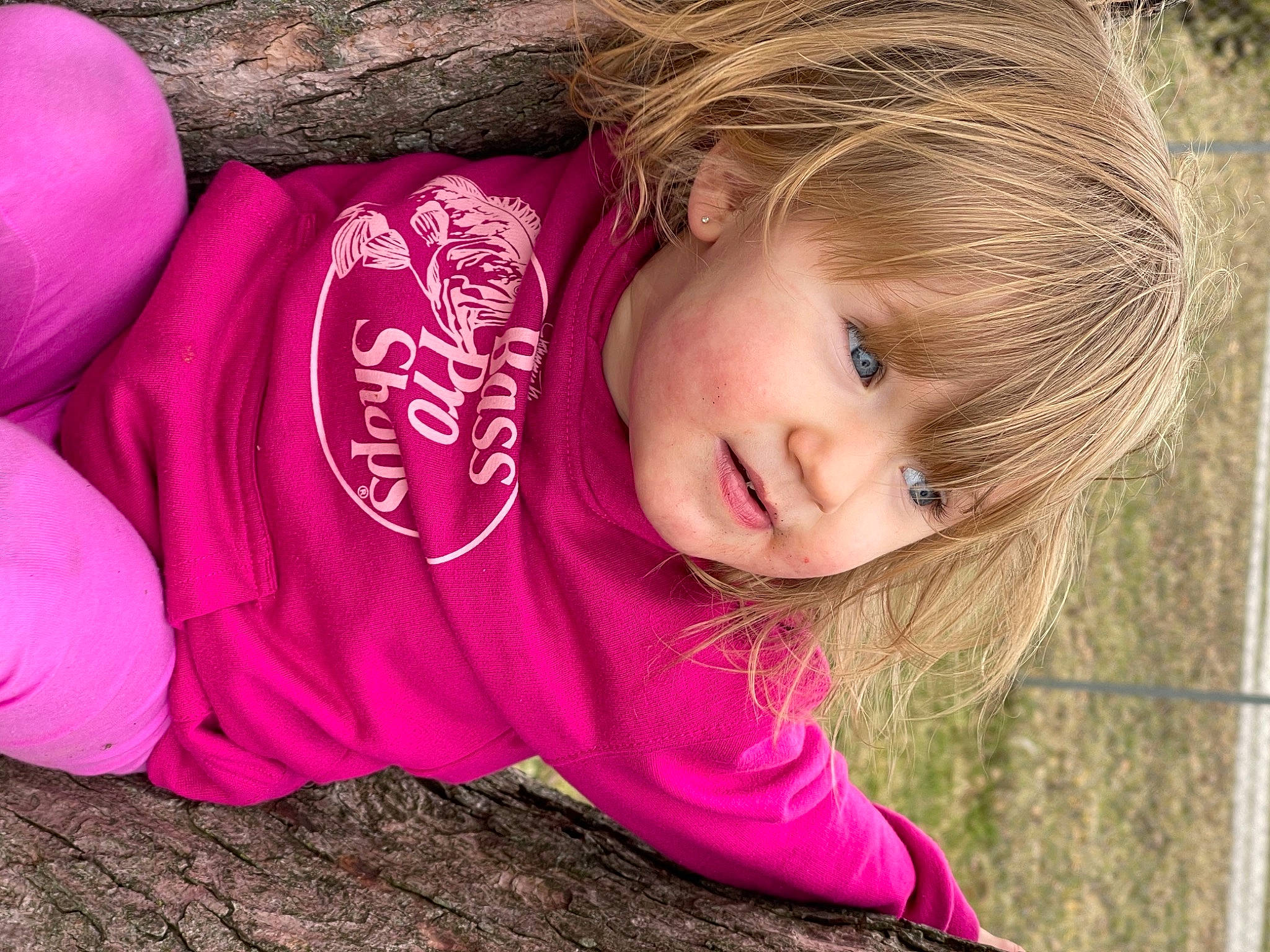 Paradise is registered to the contest to win money with this photo: cheek, child, chin, face, facial_expression, fun, grass, happy, iris, lip, mammal, outerwear, people_in_nature, person, pink, skin, smile, toddler, tree, vertebrate