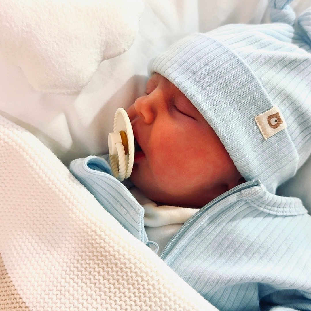 Rome is registered to the contest to win money with this photo: baby, blanket, blue_clothing, child, cozy, cute, hat, indoors, infant, knit_blanket, newborn, pacifier, peaceful, pillow, portrait, resting, sleeping, soft_texture, warm, wrapped