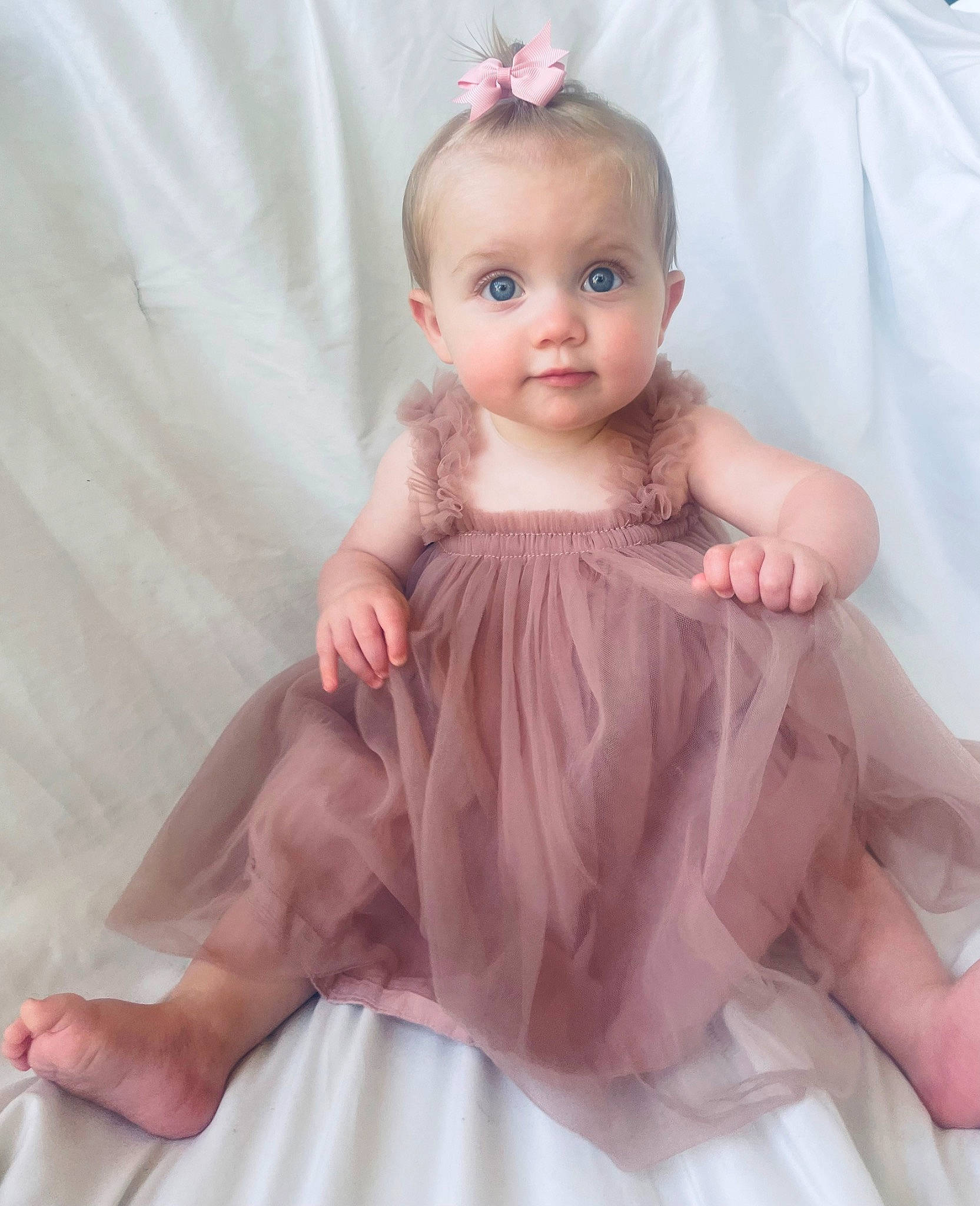 Everlee is registered to the contest to win money with this photo: baby, baby_toddler_clothing, blond, bridal_accessory, day_dress, dress, embellishment, eyelash, fashion_design, finger, headpiece, iris, one_piece_garment, pattern, person, pink, ruffle, shoulder, skin, sleeve