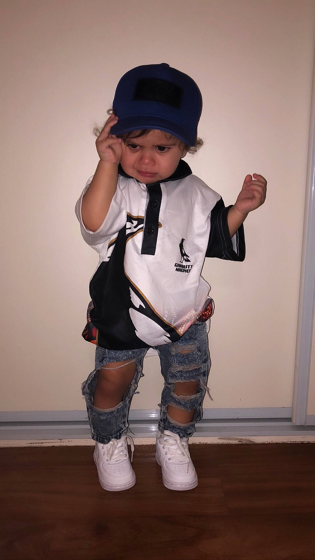 Akyem joined the competition — help win amazing prizes! child, child_model, costume, fashion_accessory, footwear, hat, headgear, knee, leg, outerwear, person, shoe, sleeve, standing, t_shirt, toddler, white