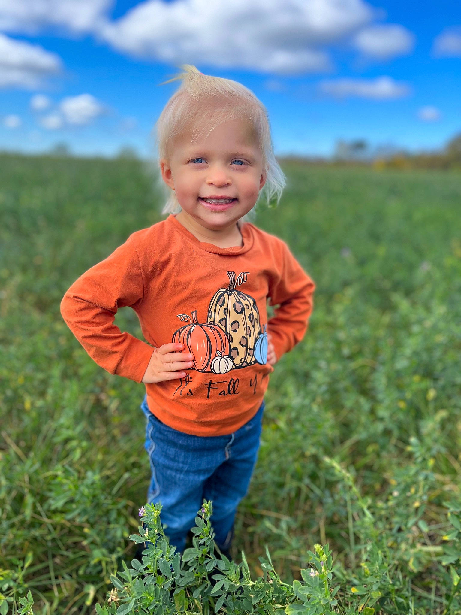 Kinsley is registered to the contest to win money with this photo: agriculture, baby, baby_toddler_clothing, child, cloud, grass, grassland, happy, jeans, joy, landscape, meadow, natural_landscape, people_in_nature, person, plant, prairie, sky, smile, t_shirt