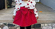Amelia joined the competition — help win amazing prizes! child, toddler, girl, portrait, outdoor, front_steps, house, door, dress, red_dress, heart_pattern, bow, hair_bows, curly_hair, smiling, standing, shoes, leggings, sidewalk, daylight
