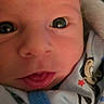 Gunner joined the competition — help win amazing prizes! newborn, baby, close_up, face, eyes, onesie, cartoon_characters, infant, cute, skin, expression, child, portrait, clothing, soft, small, head, mouth, indoor, adorable