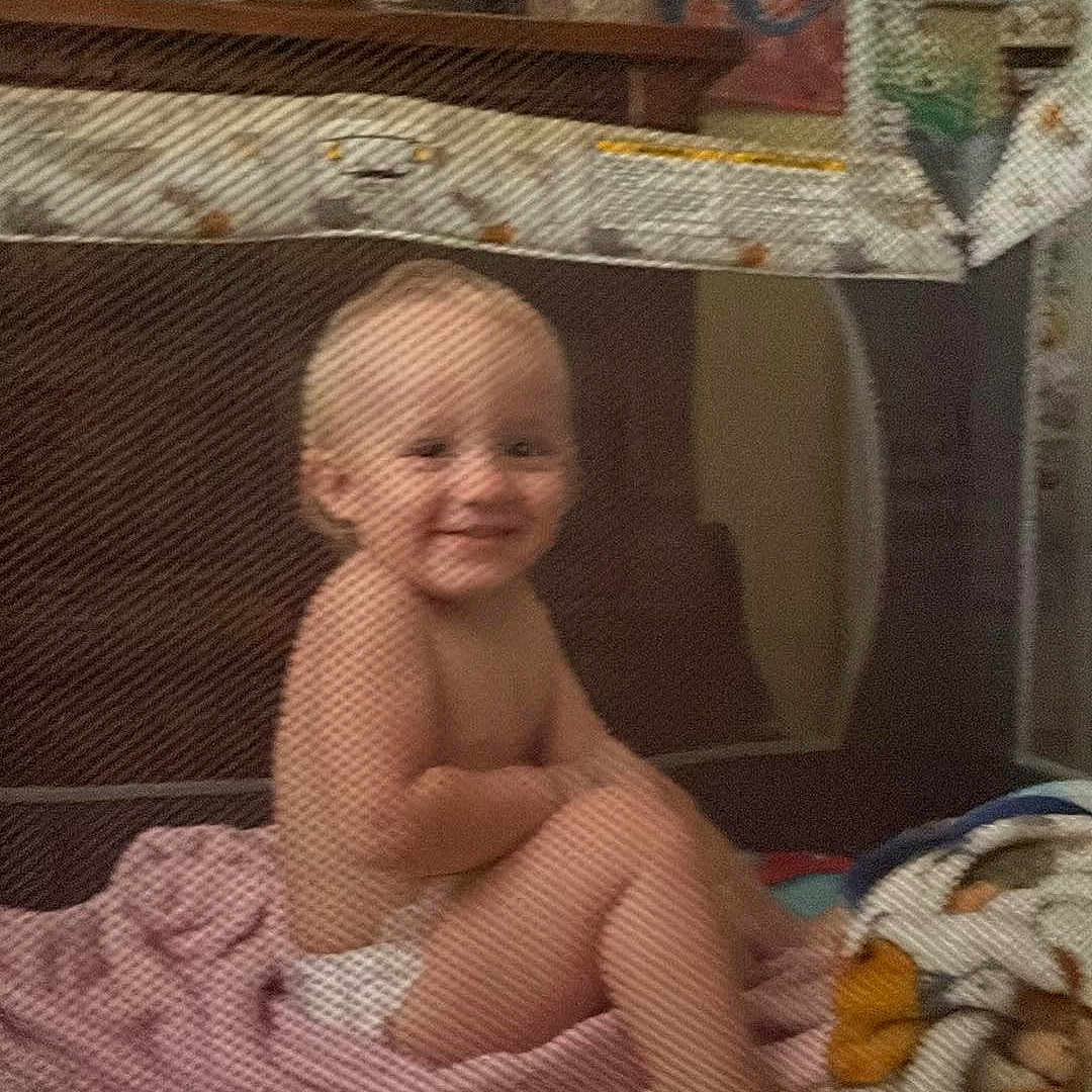 Jaxson is registered to the contest to win money with this photo: architecture, baby, bed, bedroom, blanket, building, device, face, furniture, happy, head, indoors, outdoors, person, photography, portrait, quilt, room, shelter, smile