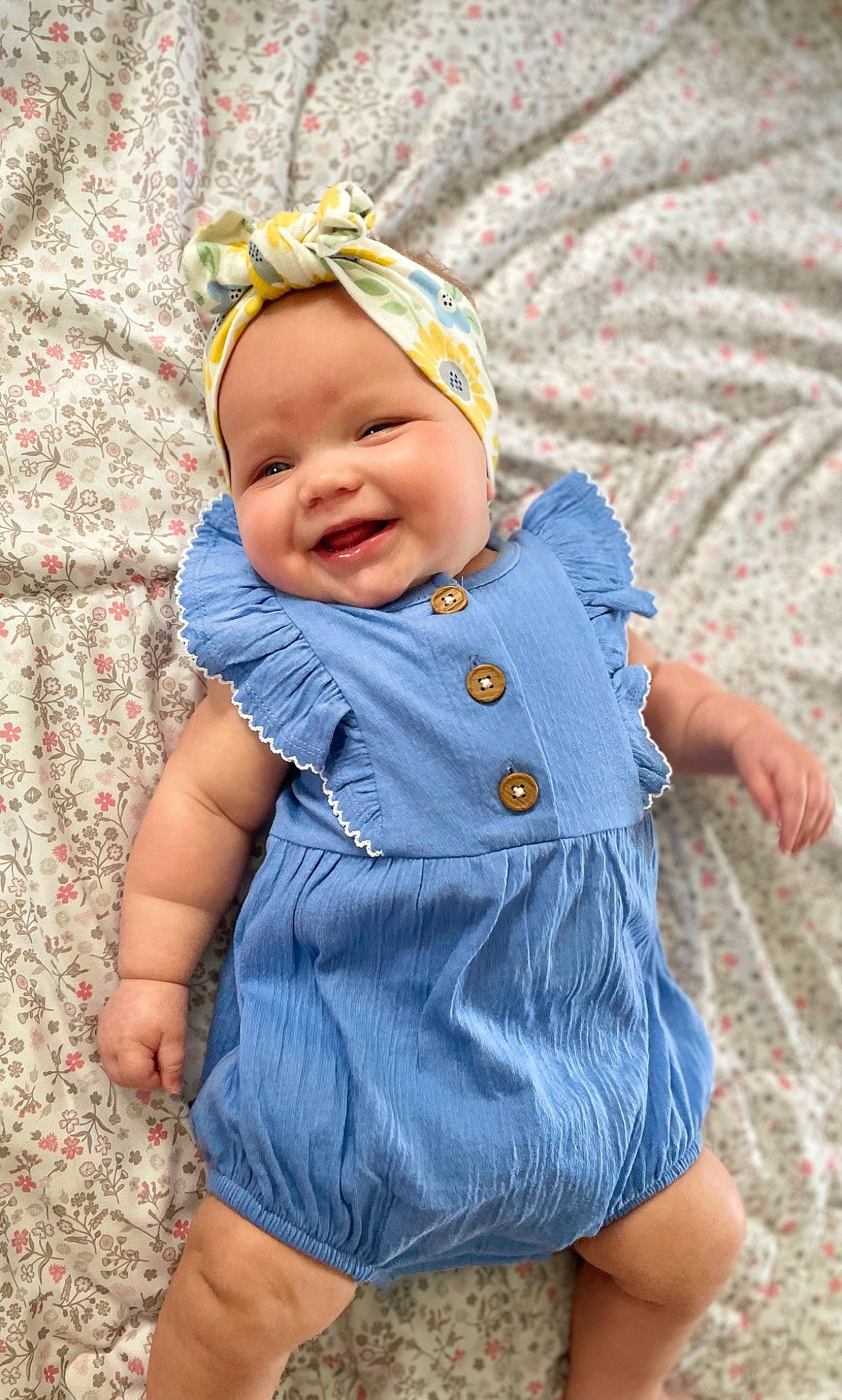 Adelaide is registered to the contest to win money with this photo: azure, baby, baby_toddler_clothing, cap, child, collar, eye, face, grass, happy, head, headwear, iris, joy, outerwear, person, pink, plant, purple, skin