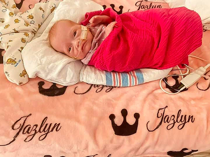 Jazlyn is registered to the contest to win money with this photo: baby, baby_sleeping, baby_toddler_clothing, bedding, bedtime, child, comfort, font, happy, jewellery, linens, magenta, pattern, person, photo_caption, photograph, pink, room, sleeve, textile