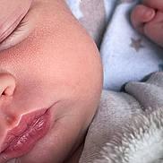 Lottie is registered to the contest to win money with this photo: baby, sleeping, close_up, face, skin, blanket, hand, peaceful, infant, newborn, cozy, soft, cute, lips, nose, eyelashes, fingers, warm, rest, heart_emoji
