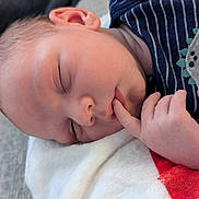 Bryson is registered to the contest to win money with this photo: baby, blanket, child, closeup, clothing, comfort, cozy, cute, face, finger, hand, infant, nap, newborn, peaceful, portrait, resting, skin, sleeping, soft