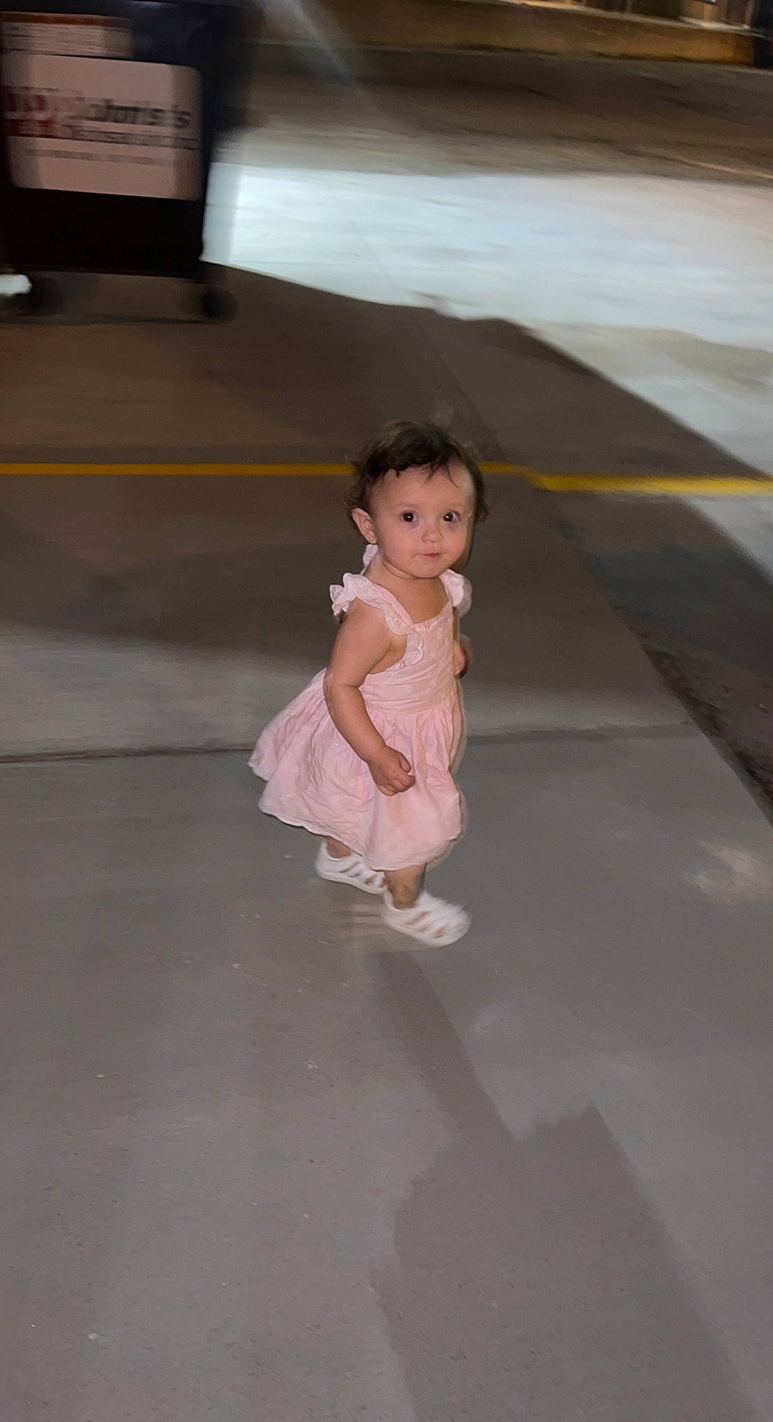 Dahlia joined the competition — help win amazing prizes! asphalt, baby, baby_toddler_clothing, child, concrete, dress, floor, flooring, foot, fun, hardwood, human_leg, person, recreation, road, road_surface, sandal, shadow, sitting, toddler