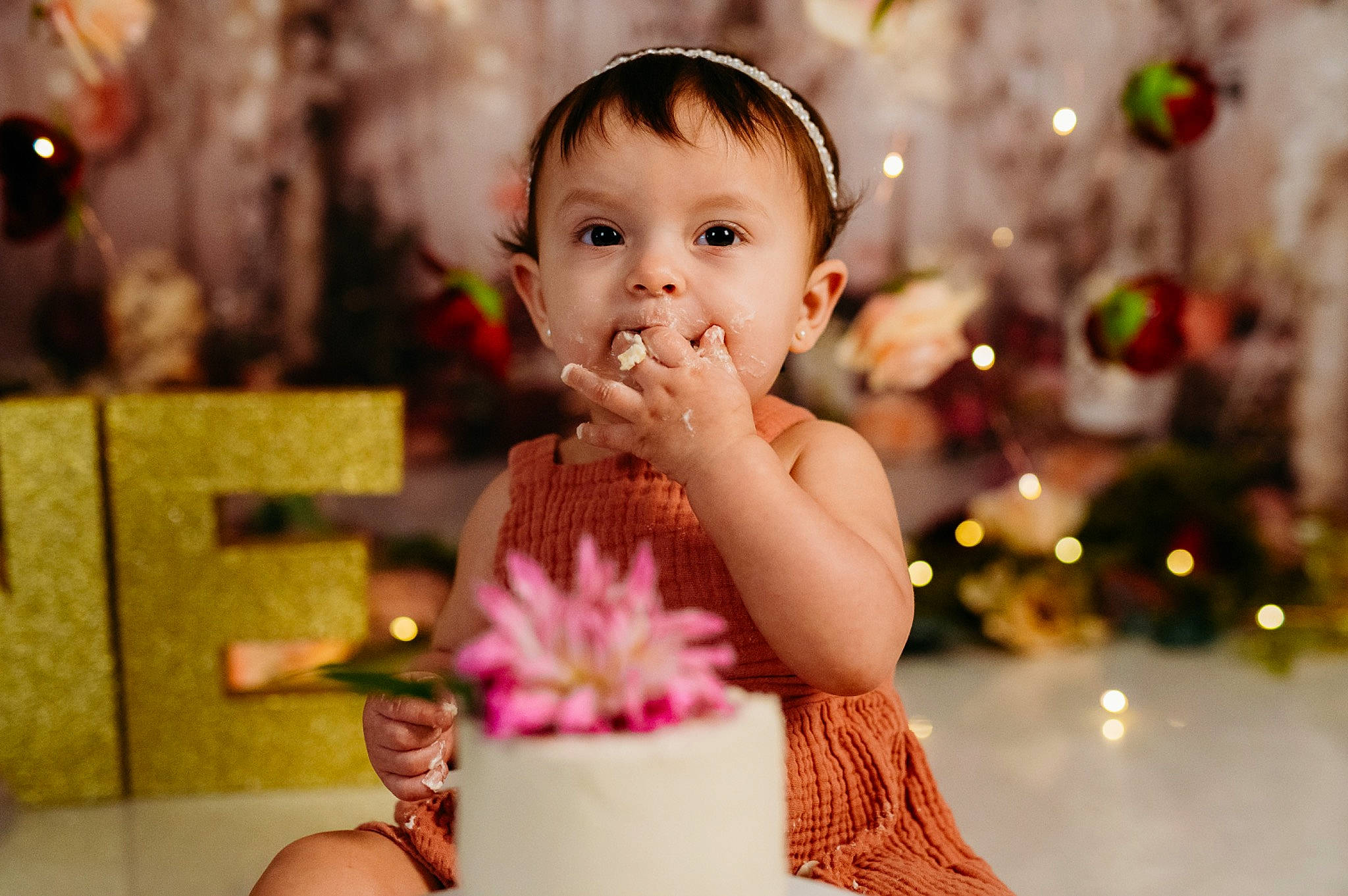 Dahlia is registered to the contest to win money with this photo: baby, birthday, child, christmas_tree, dress, event, facial_expression, flash_photography, fun, happy, human, people_in_nature, person, petal, plant, portrait_photography, sitting, sugar_cake, sweetness, toddler