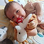 Shelly participe au concours pour gagner de l'argent avec cette photo : baby, infant, pacifier, plush_toy, soft_toy, play_mat, child, cute, smiling, toy, lying_down, indoors, happy, young_child, closeup, face, hand, comfort, cuddly, babywear