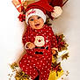 baby, celebration, child, christmas, cute, decoration, festive, gifts, happy, hat, holiday, indoors, lying_down, polka_dot, portrait, red_clothing, santa_claus, seasonal, smiling, wrapped_presents