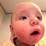 Julius is registered to the contest to win money with this photo: baby, close_up, face, child, indoor, curious, rosy_cheeks, wide_eyes, expression, head, skin, portrait, infant, cute, young, human, person, mouth, nose, ear
