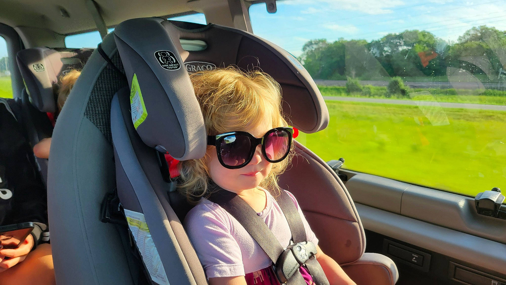 Izzy joined the competition — help win amazing prizes! auto_part, automotive_design, automotive_exterior, automotive_mirror, car_seat, eyewear, fun, goggles, head_restraint, leisure, person, personal_protective_equipment, plant, seat_belt, sky, sunglasses, toddler, travel, tree, vehicle_door