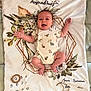 Charlie a rejoint le concours — aidez-le/la à gagner de superbes lots ! animal_print, arms, baby, baby_clothes, bed, blanket, cushion, decor, face, floral_pattern, geometric_shape, happy, home, infant, laying_down, legs, onesie, skin, smiling, wooden_ring